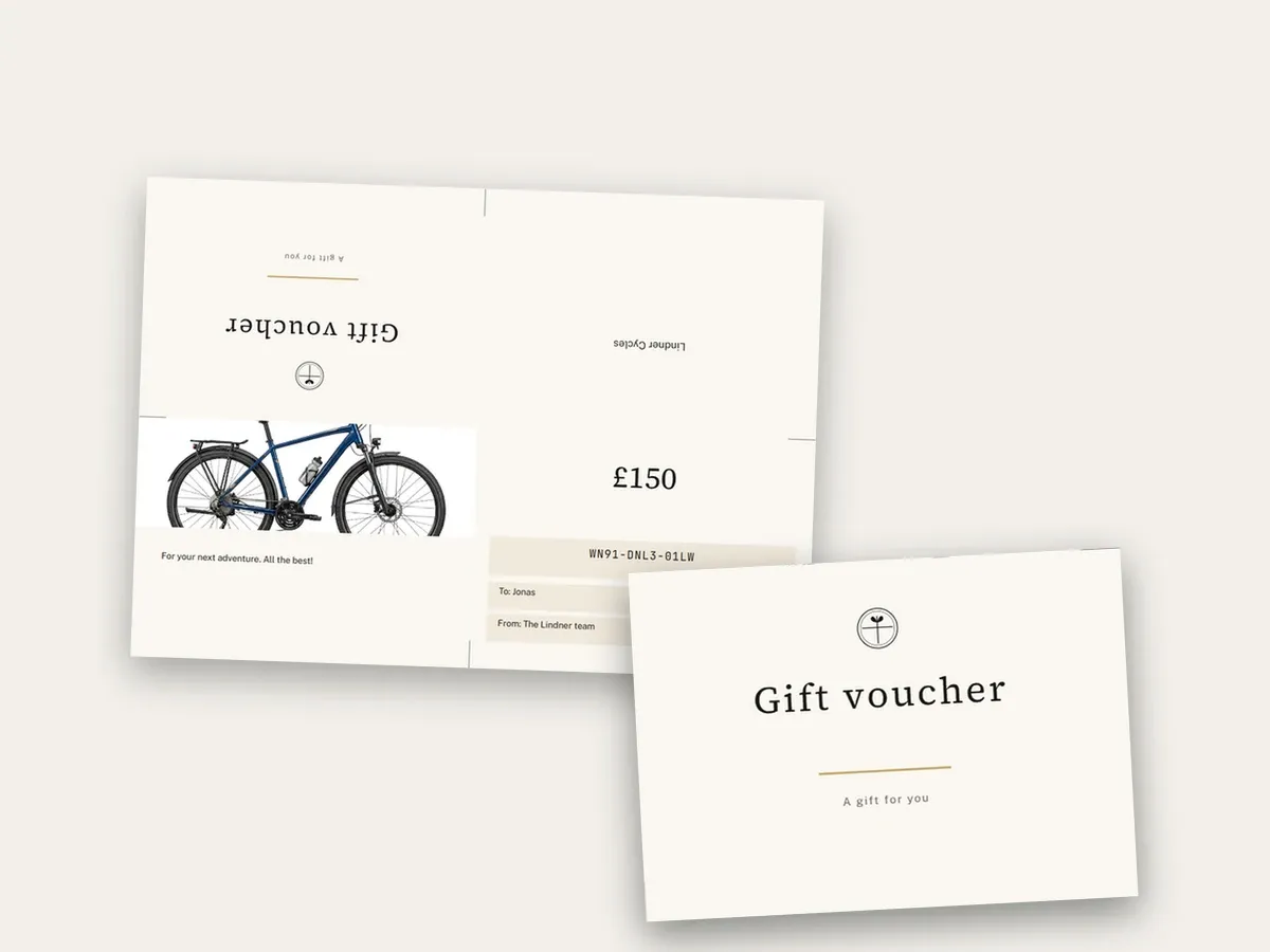Printed A4 sheet with fold marks for the cross fold, in front of it the finished folded card with the front page “Gift voucher”